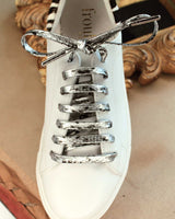 Lacets motif lézard argent